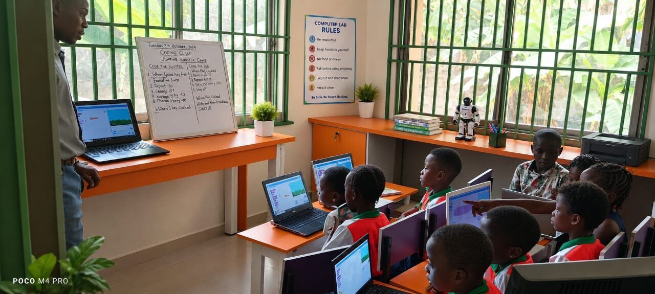 Pupils at laptops in the ROIS computer lab during a coding class