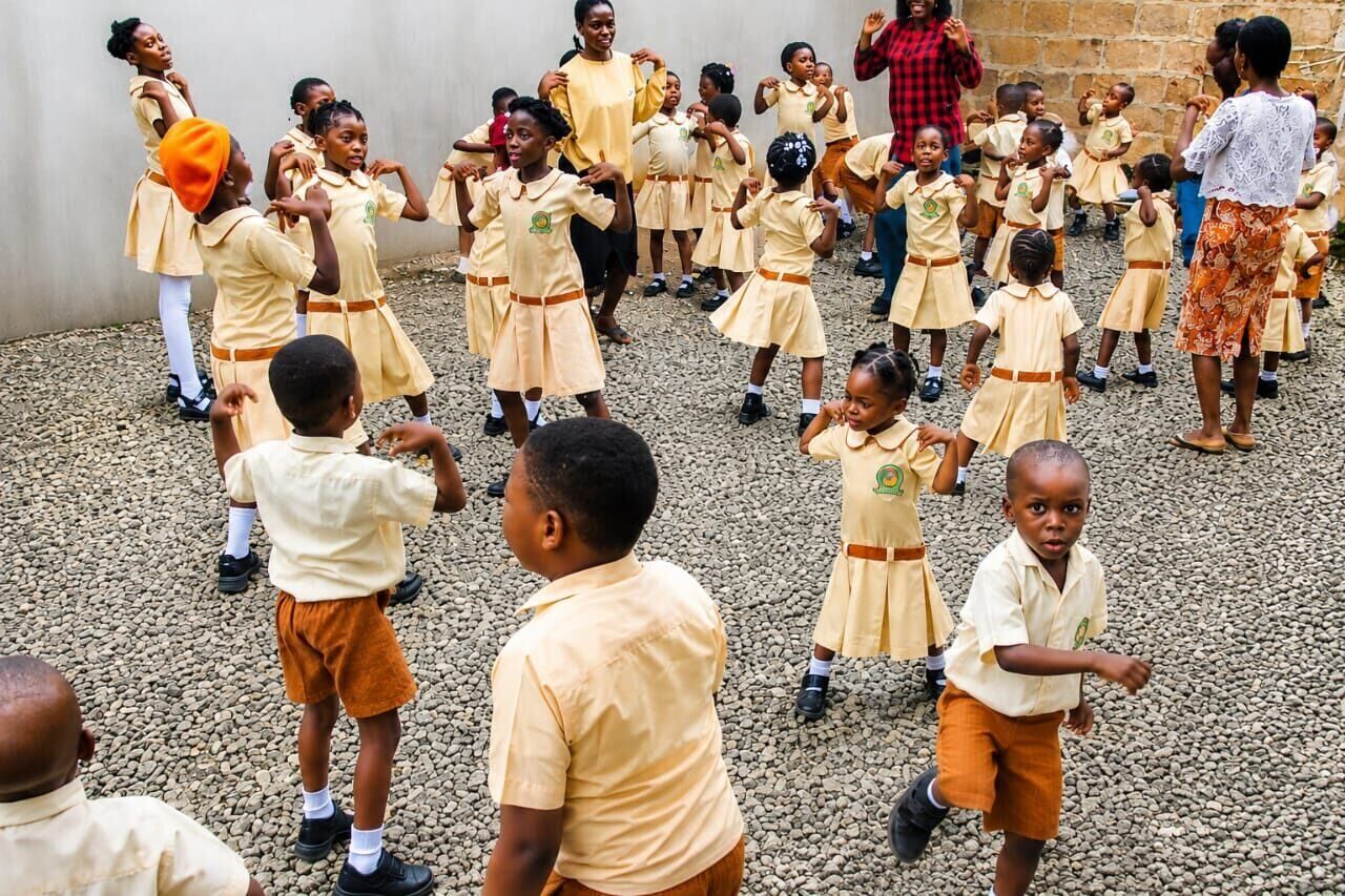 KG 1 pupils dancing in a circle on the schoolyard